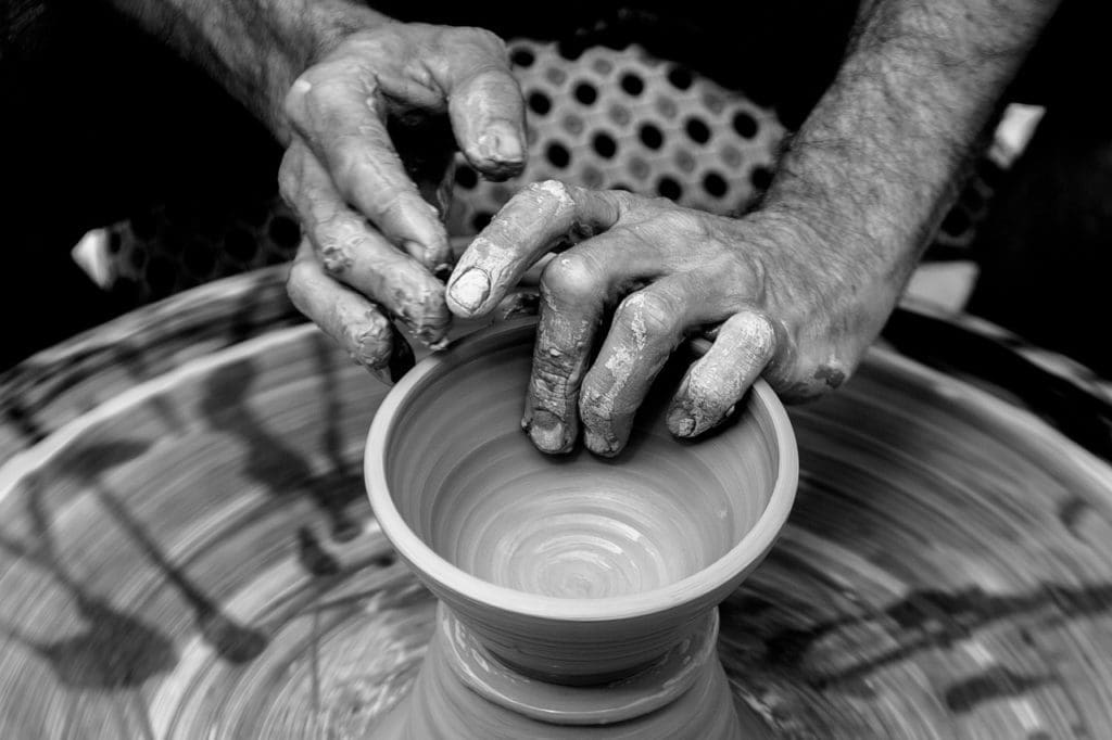 Potter's hands making a vessel to be used.