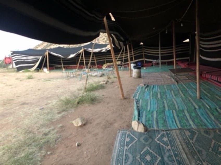 Bedouin tent in Wadi Dana, biblical Edom, in southern Jordan. The Bedouin set their tents up in either an L shape, or a U shape. The back is toward the prevailing winds of the area.This tent is set up in the traditional fashion with cushions for sitting or reclining. Abraham was most likely sitting in the door to get a bit of breeze, without leaving the shade of the tent when he saw the heavenly visitors approaching. Photo by John Buckner