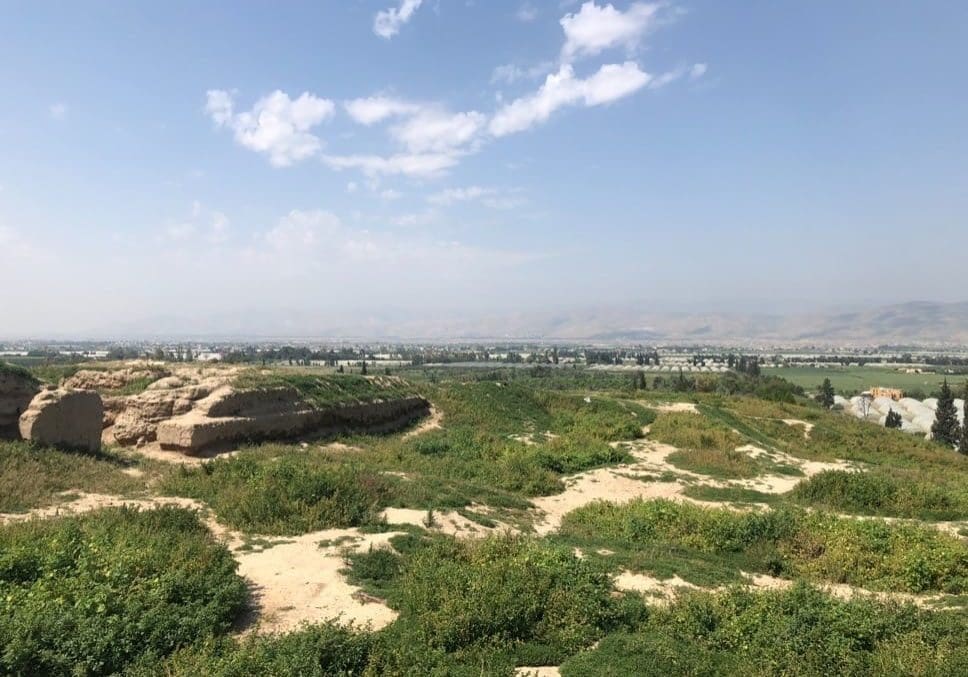 The ruins of Succoth/Tell Deir Alla looking west toward the plains of Jordan, the river valley, and the river itself. In the distance are the hills of Samaria. Photo by John Buckner