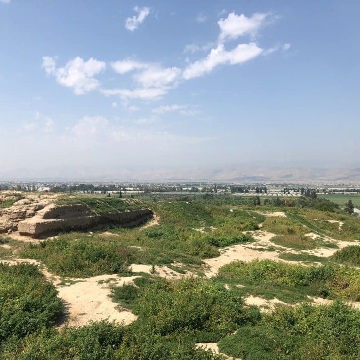 The ruins of Succoth/Tell Deir Alla looking west toward the plains of Jordan, the river valley, and the river itself. In the distance are the hills of Samaria. Photo by John Buckner