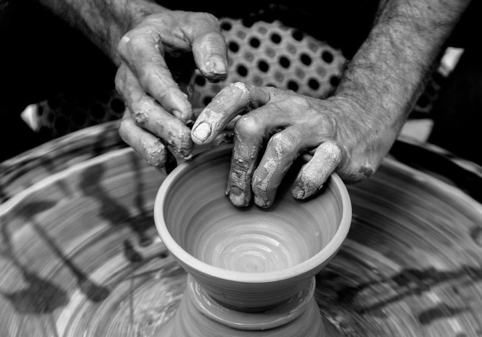 Potter's hands making a vessel to be used.